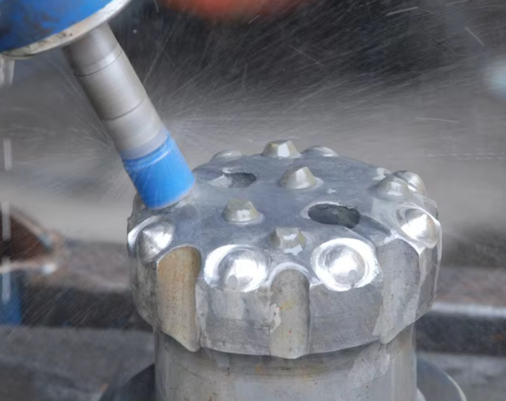Picture of the drill bit being repaired by the machine